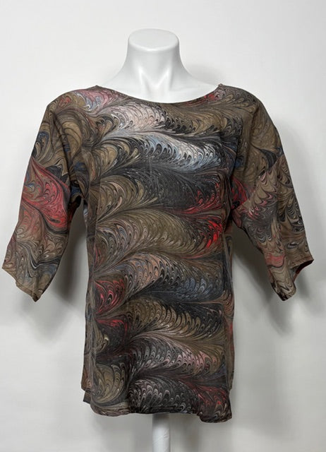 Marbled patterned shirt on a mannequin against a white background