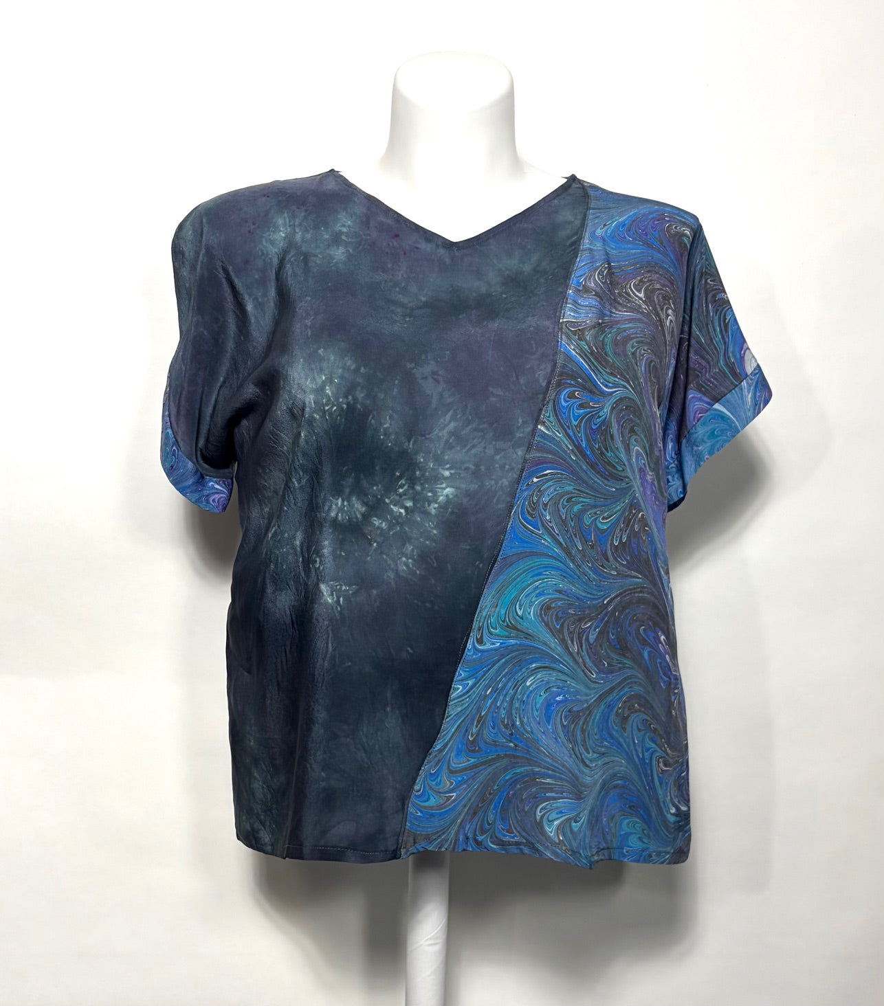 Hand dyed silk top with marbled assymetric piece on left side on a mannequin against a white background