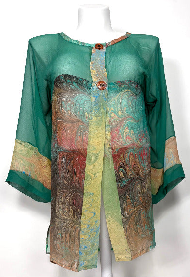 Mannequin wearing a green silk and marbled silk jacket on a white background