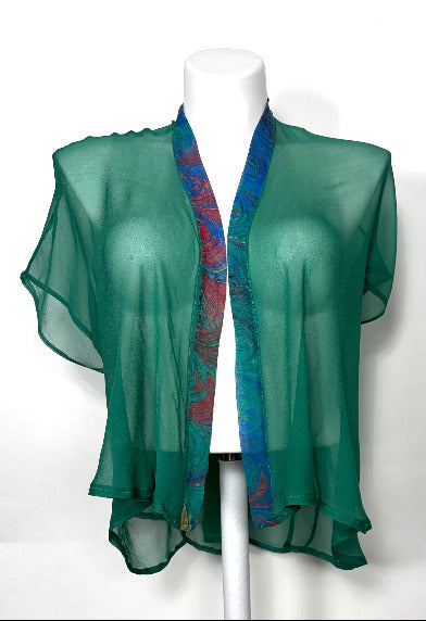 Green sheer top with a colorful marbled trim on a white background