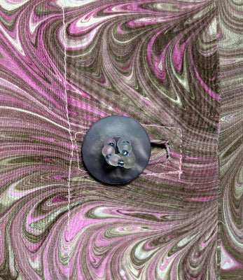 Close-up of the buttons on a marbled silk jacket