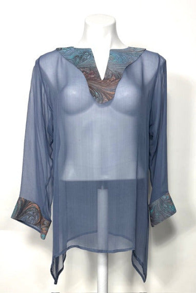 Sheer gray tunics with marbled silk trim on neck and cuffs on a mannequin against a white background