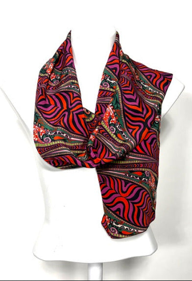 Colorful patterned scarf on a mannequin against a white background