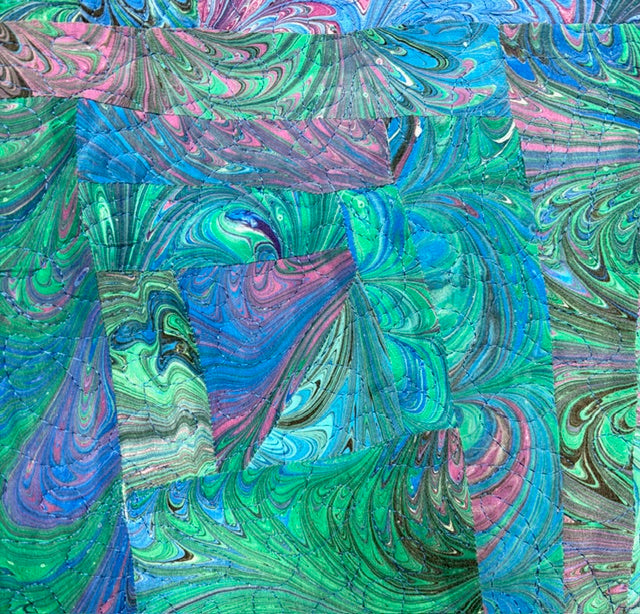 Close up of colorful abstract pattern made up of marbled silk pieces quilted