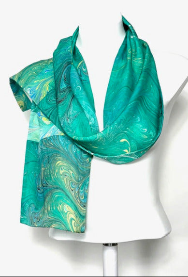 Green marbled scarf on a mannequin against a white background