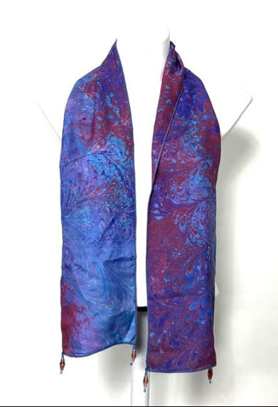 Blue and purple marbled silk scarf on a white background