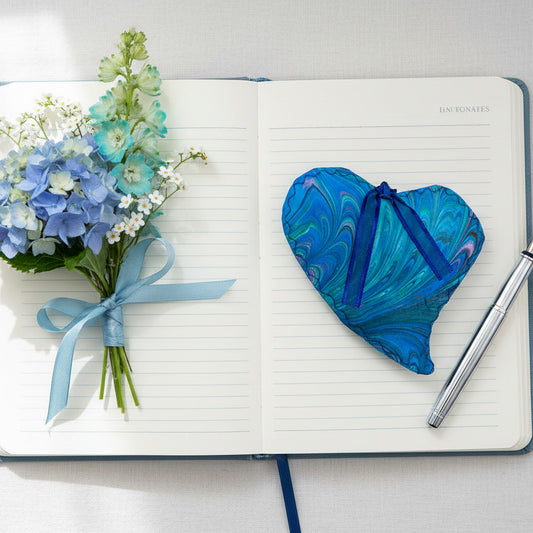 FLAT marbled silk fabric heart in blues and soft green with some pink shown with journal and flowers