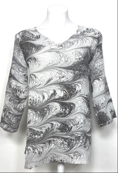 Marbled black and white silk tunic on a mannequin against a white background