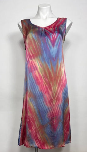 Colorful shibori dyed silk satin dress on a mannequin against a white background