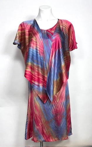 Colorful shibori dyed silk satin dress with a jacket on a mannequin against a white background
