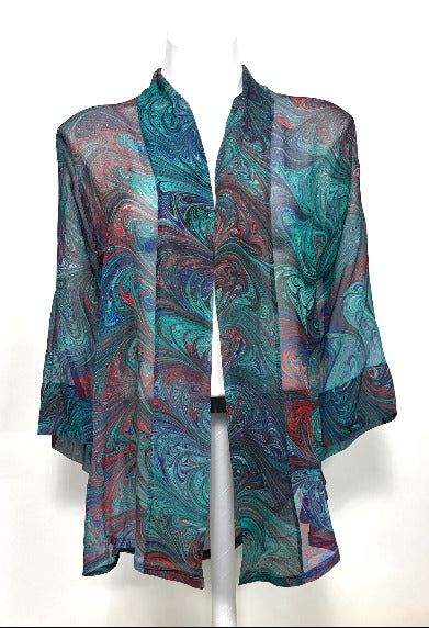 Colorful marbled silk kimono jacket on a mannequin against a white background