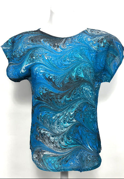 Blue and black marbled silk  top on a mannequin against a white background