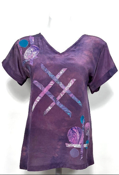 Purple hand dyed silk t with abstract designs on a white background