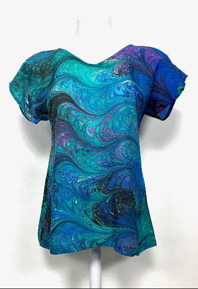 Blue and green marbled silk top on a white background