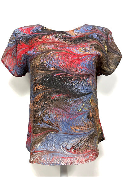 Colorful marbled silk top on a mannequin against a white background
