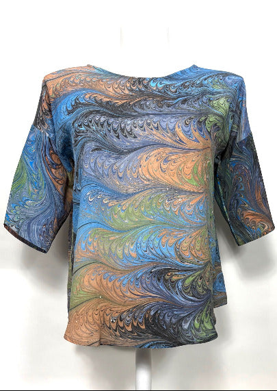 Colorful marbled silk patterned top on a white background