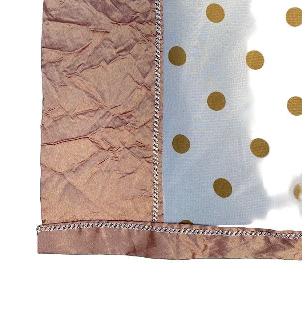 Trim detail on white and gold poncho