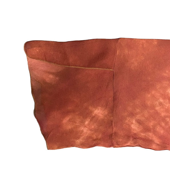 Brown silk jacket sleeve detail on white background