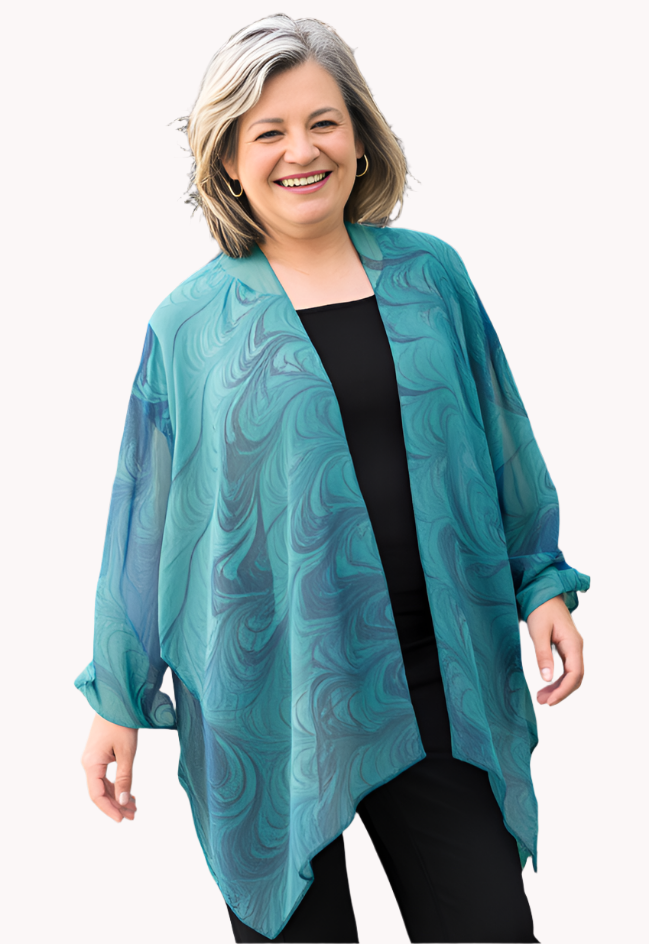 Woman wearing a marbled sheer silk wrap jacket over a black top 