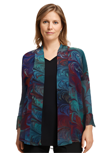 Woman wearing a colorful marbled silk jacket over a black top and pants against a white background