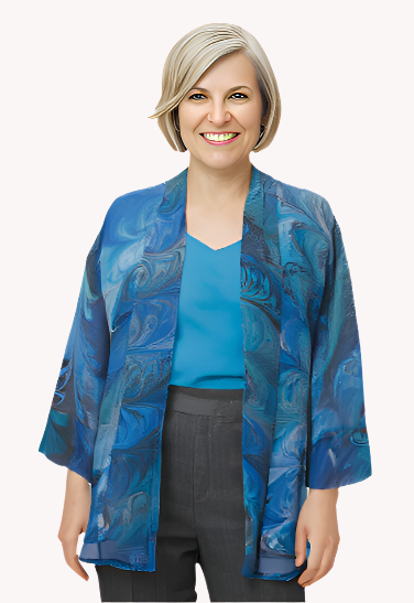 Woman wearing a blue silk marbled  jacket over a teal top and black pants on a white background