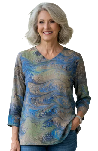 Woman wearing a marbled silk top and blue jeans standing on a patio.