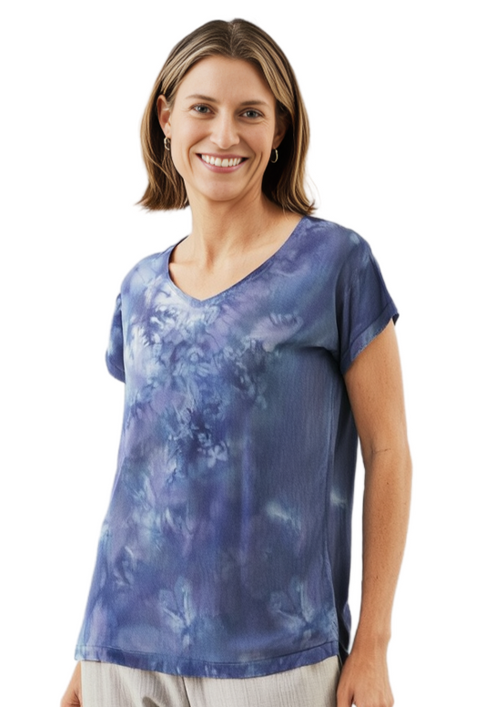 Woman wearing a gray hand dyed silk  shirt on a white background