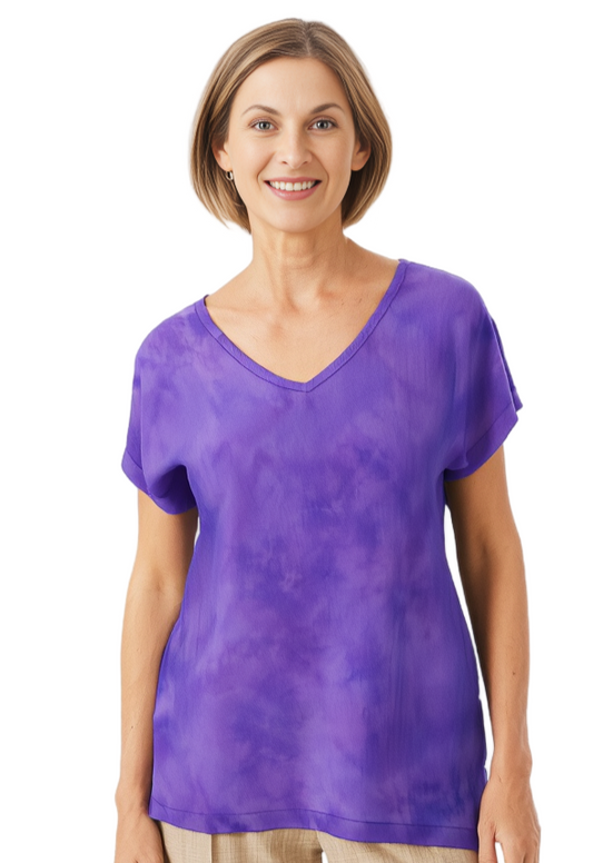 woman wearing a hand dyed silk t in violet against a white background