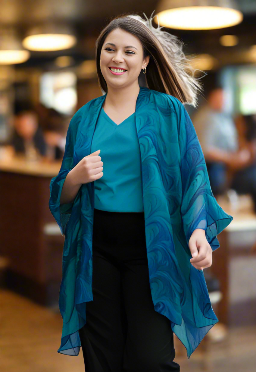 woman wearing a marbled blue and green silk jacket wrap at a restaurant