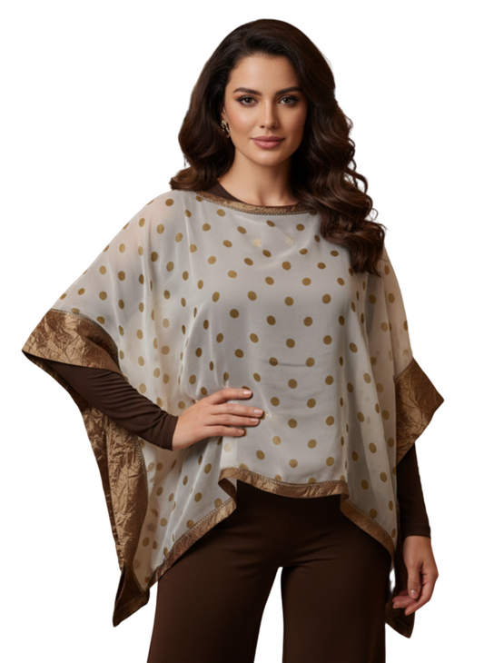 Woman wearing a polka dot  poncho and brown pants 
