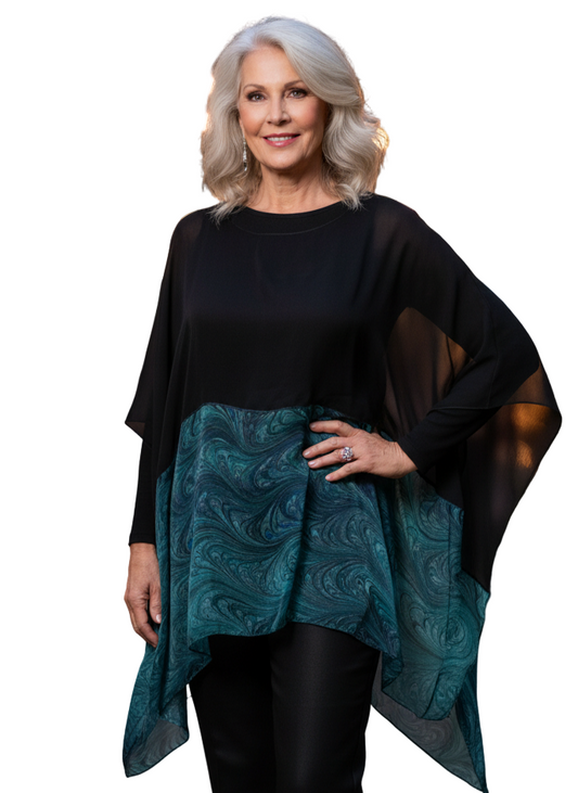 Woman wearing a black and marbled emeralds poncho