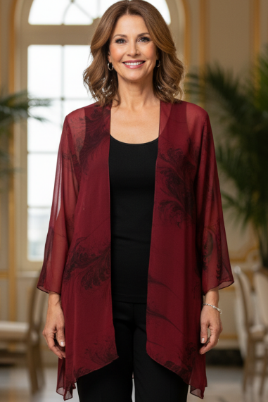 Woman wearing a marbled silk sheer jacket  in an elegant indoor setting.
