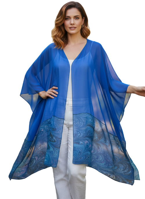 woman wearing blue sheer ruana against a white backdrop