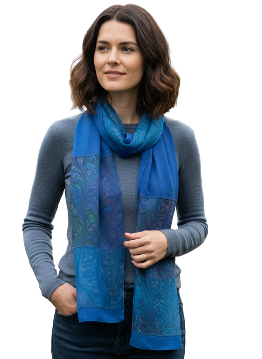 Woman wearing a blue marbled silk scarf in a garden setting
