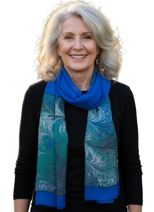 Woman wearing a blue and green marbled silk scarf 