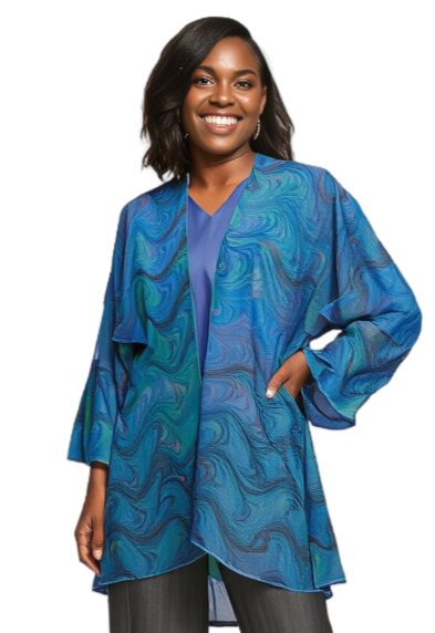 woman wearing a marbled silk wrap jacket in soft blues with a touch of green, red