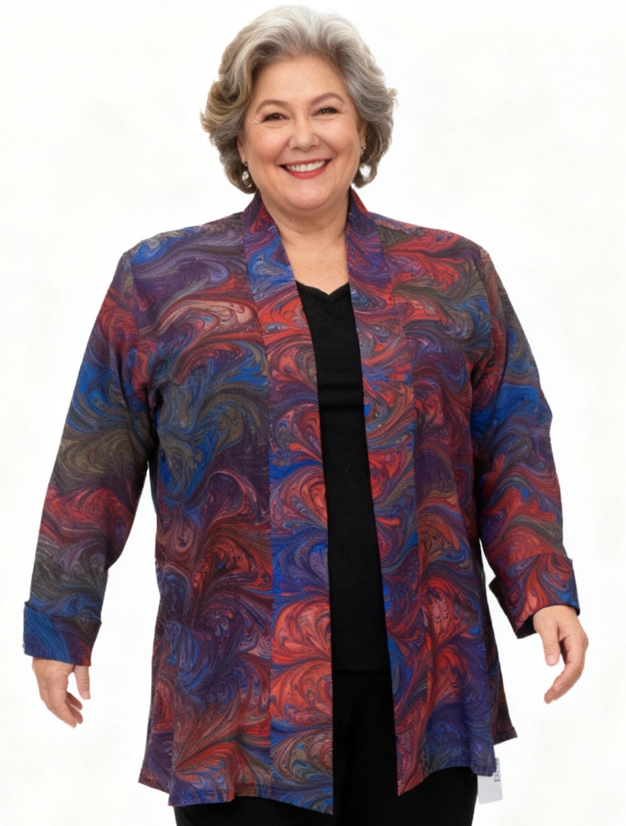 Woman wearing a colorful hand marbled silk swing jacket and black pants on a white background