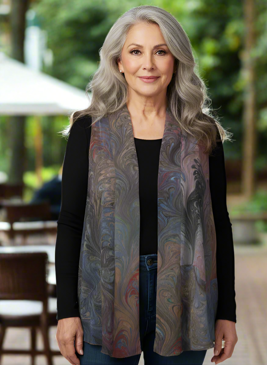 Woman wearing a marbled silk vest outdoors with blurred background