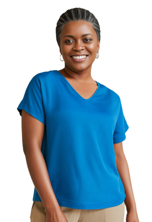 Woman wearing a hand dyed blue silk t-shirt on a white background