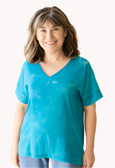 Woman wearing a jade hand dyed silk shirt and jeans 