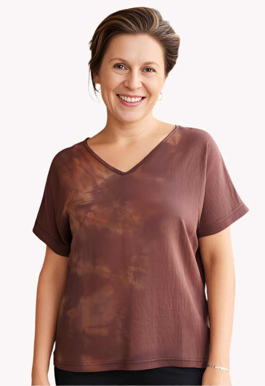 Woman wearing a hand dyed brown silk  t shirt  and black pants.