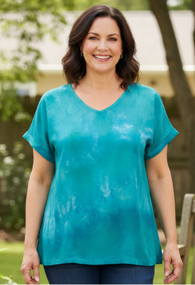 woman wearing a hand dyed silk t standing in a park setting