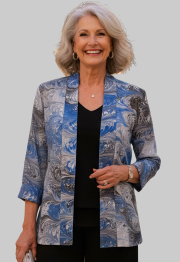 Woman in a blue black and white marbled silk jacket and black pants 