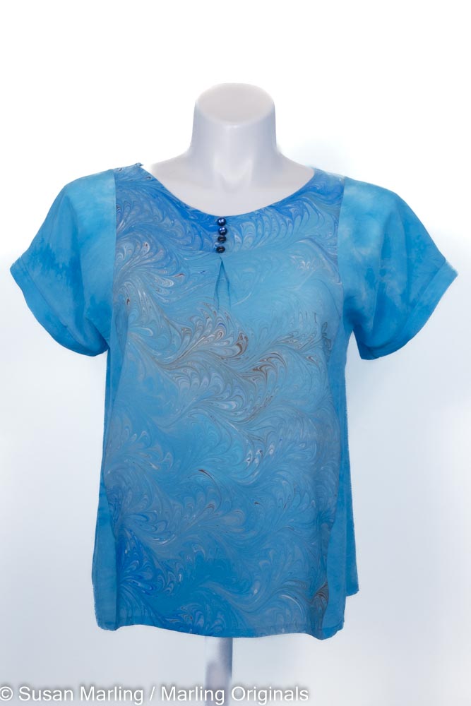 turquoise silk blouse with marbled blue center front. round neck. Short sleeves