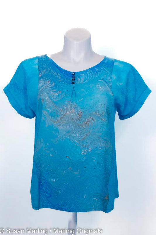 turquoise silk blouse with marbled blue center front. round neck. Short sleeves