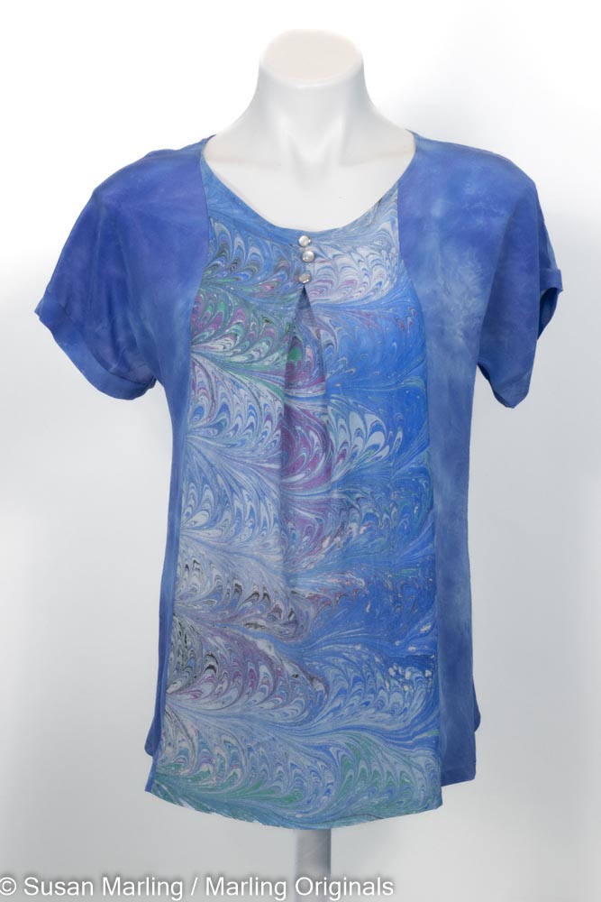 blue silk shirt with marbled inset in front center. Short sleeves. Round neck