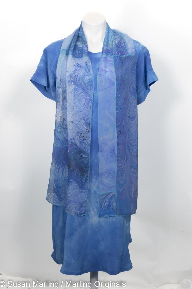 blue hand dyed silk dress with mottled pattern shown with collage scarf.  Short sleeves.  Round neck