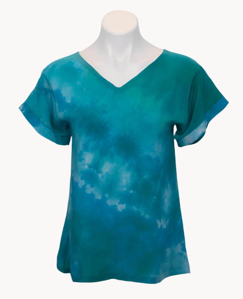 Teal tie-dye t-shirt on a mannequin against a white background