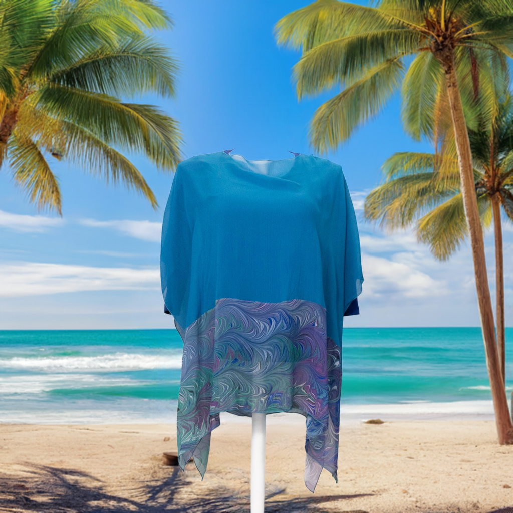 silk poncho displayed on a beach 