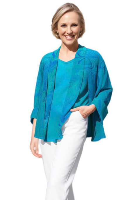 Woman wearing a blue top and white pants on a white background